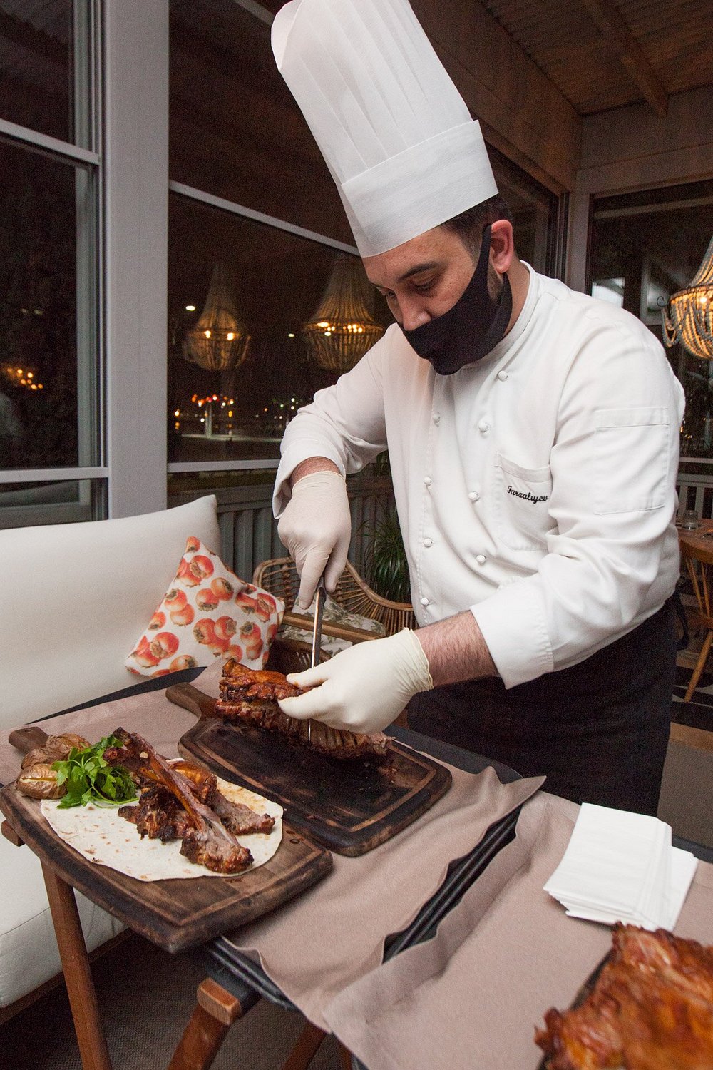 A chef finishing a dish at the table