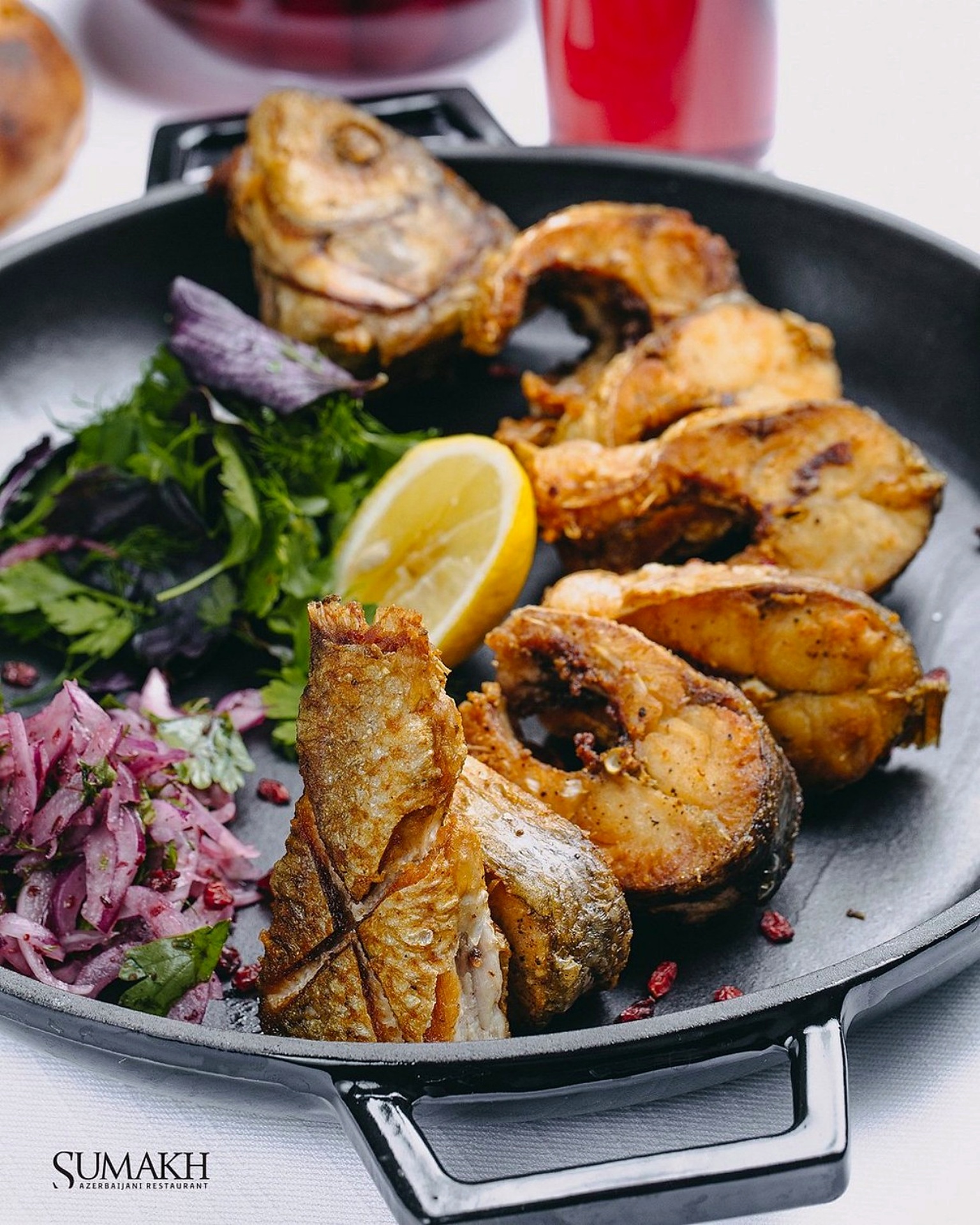 Pan-fried fish steaks with herbs, lemon and red onion salad at Sumakh in Baku