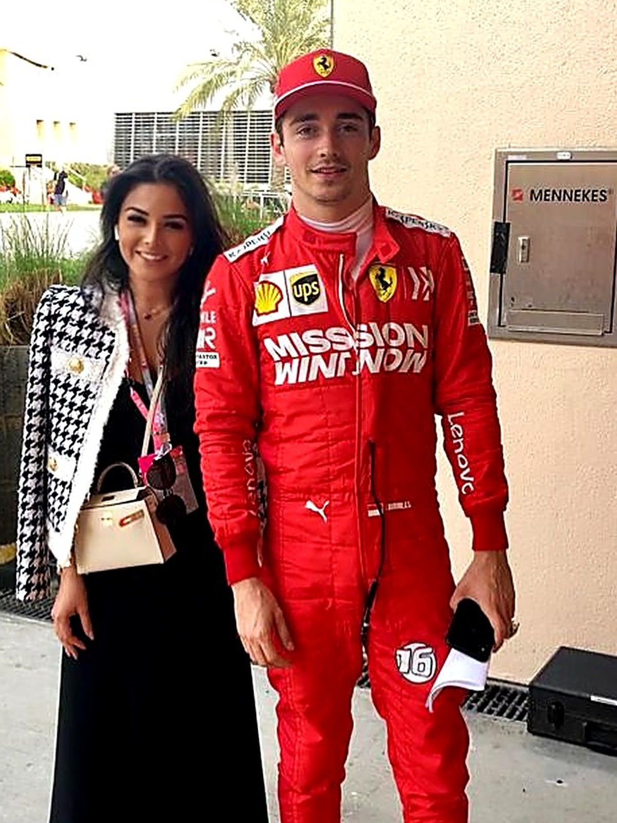 Kamila Verdiyeva in the Formula 1 paddock with a driver in racing overalls