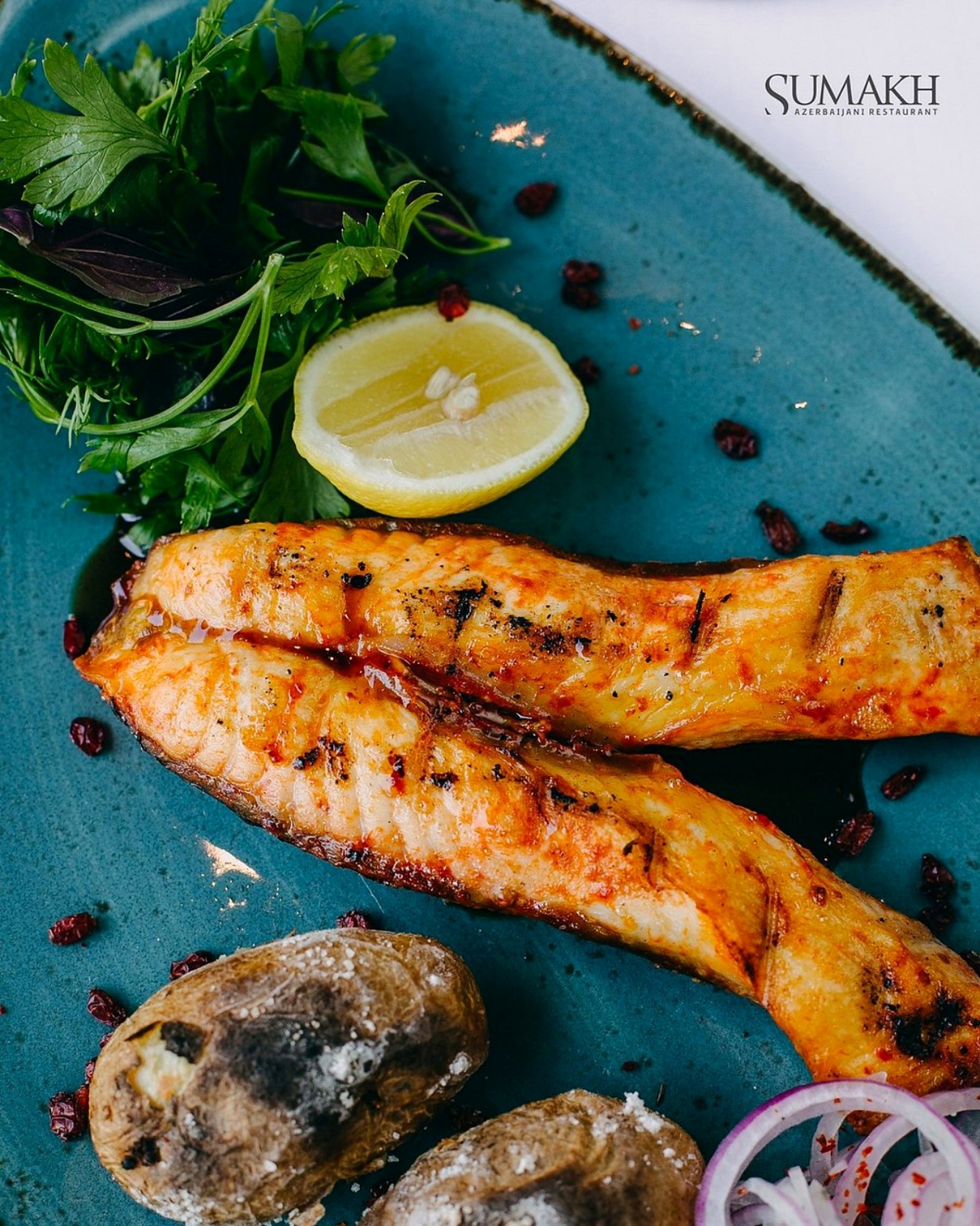 Grilled Caspian fish with herbs, lemon and salt-baked potatoes at Sumakh in Baku