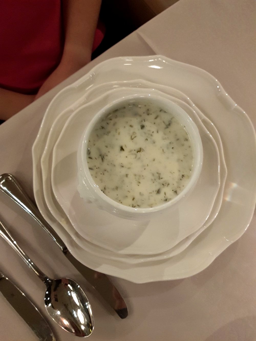 Dovğa — warm yoghurt and herb soup served in porcelain at Shur in Baku