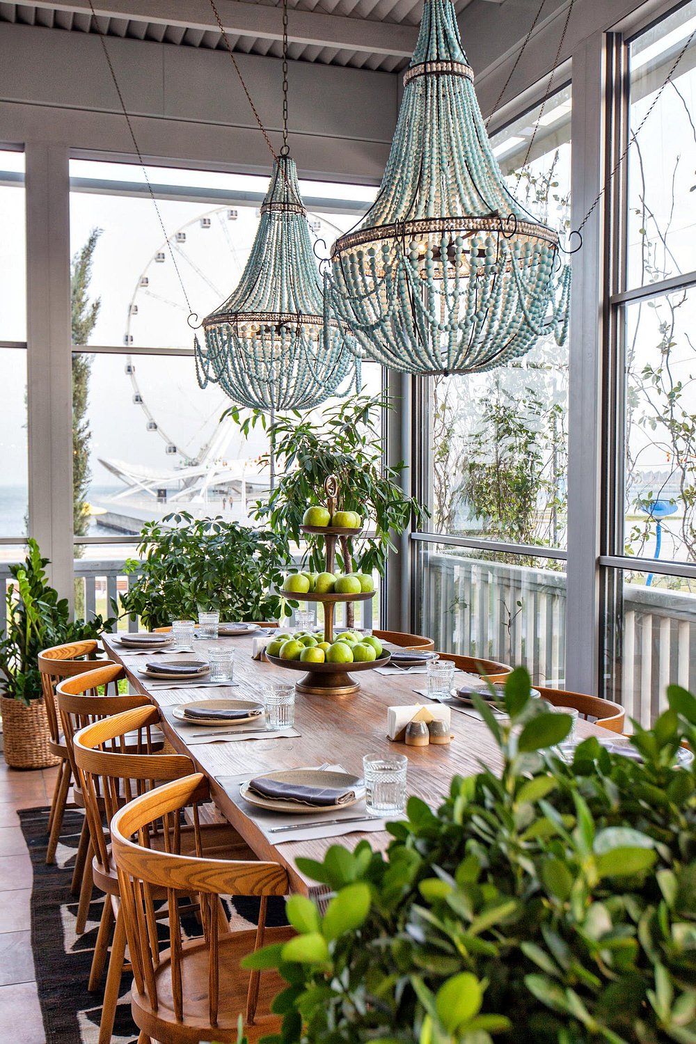 The glazed all-season terrace at Chayki Restaurant in Baku, planted and set for dinner