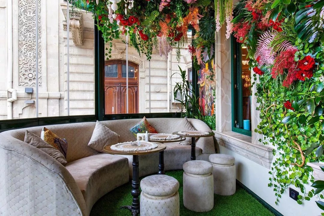 A table laid for dinner in Baku beneath hanging flowers and greenery